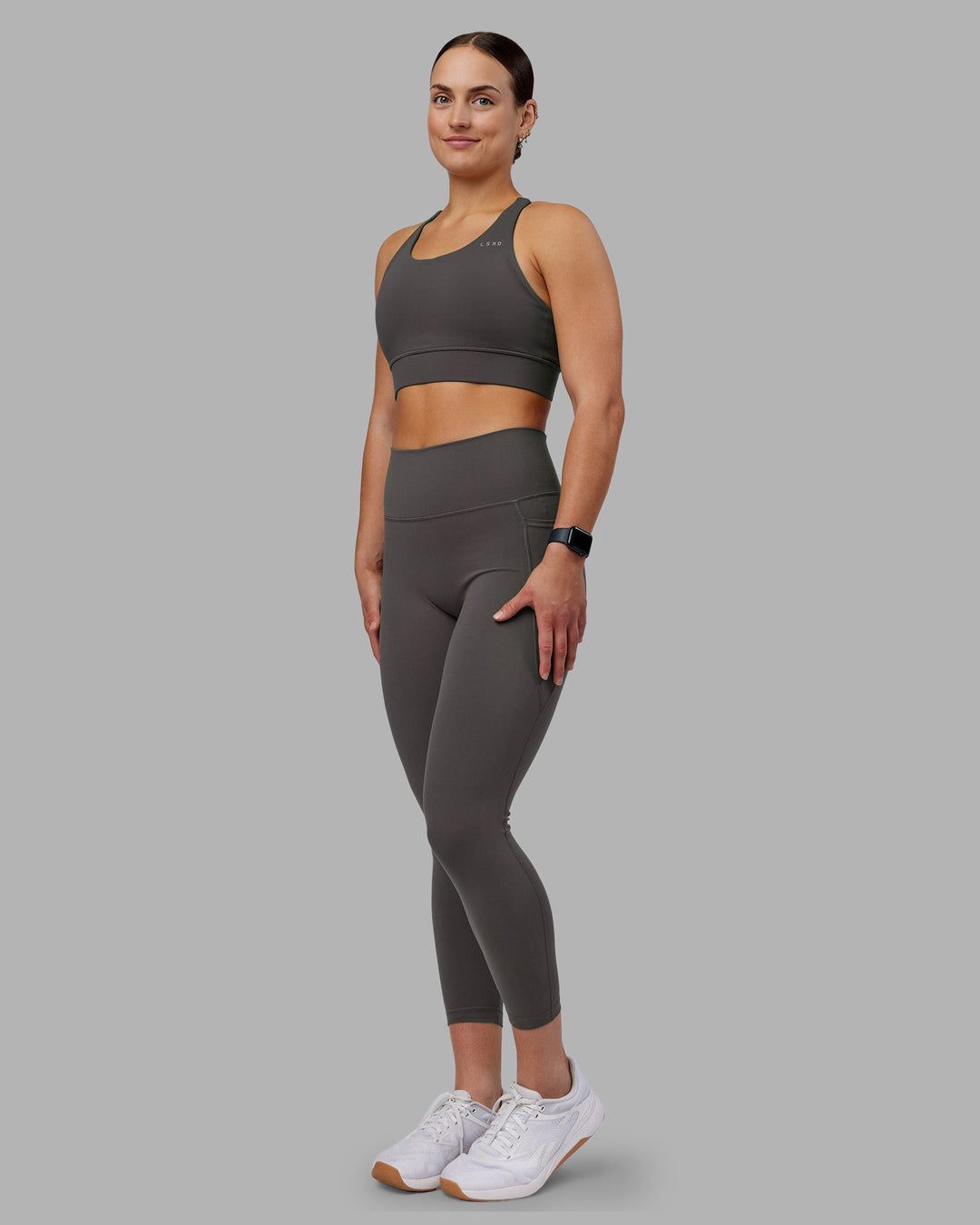 Woman wearing Fusion Ultra High-Rise 7/8 Legging Pockets - Dark Storm | Model:Keisha | Size:S
