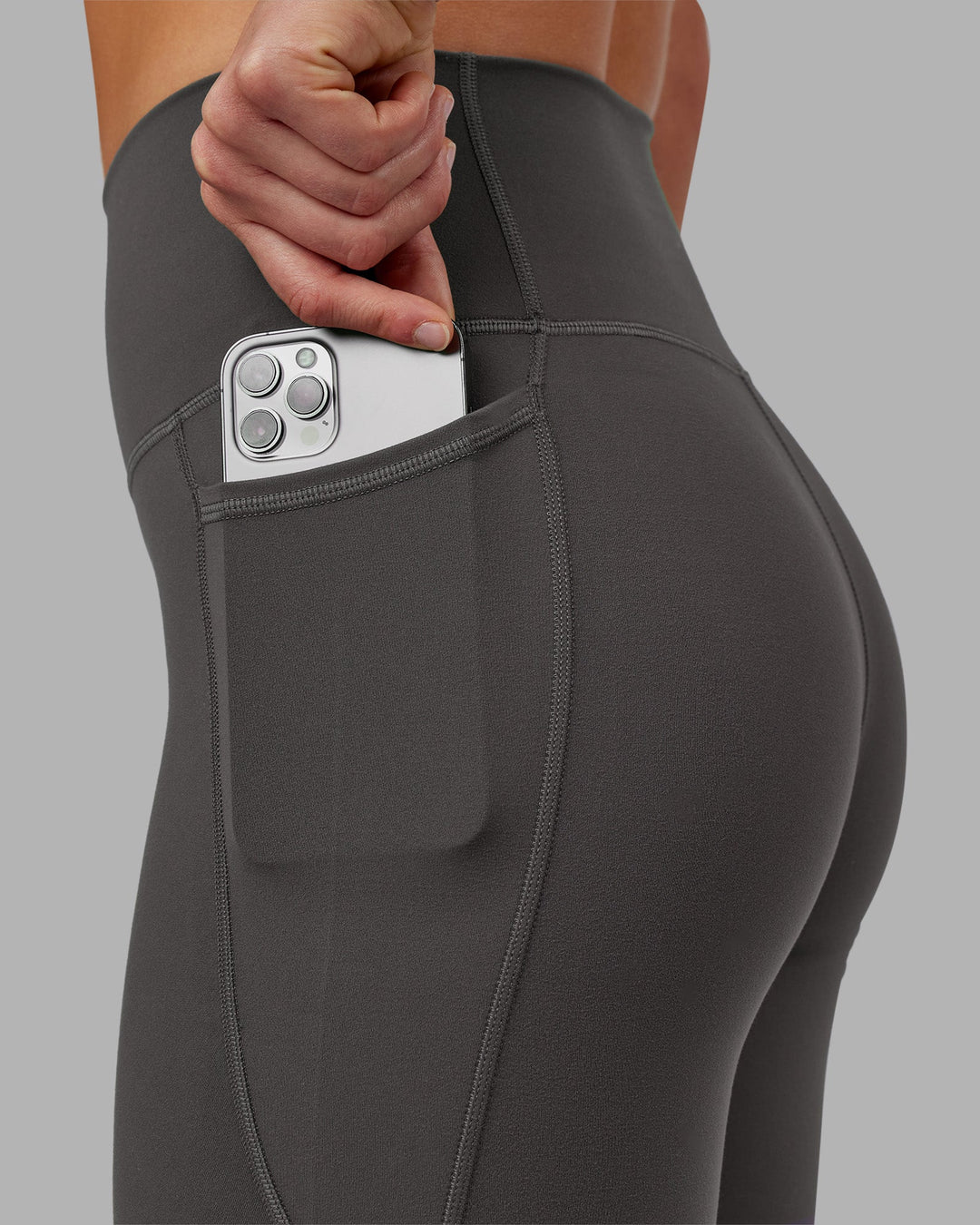 Woman wearing Fusion Ultra High-Rise 7/8 Legging Pockets - Dark Storm | Model:Keisha | Size:S