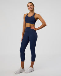 Woman wearing Fusion Ultra High-Rise 7/8 Legging Pockets - Future Navy | Model:Evie | Size:S