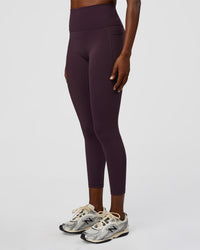 Woman wearing Fusion Ultra High-Rise 7/8 Legging Pockets - Midnight Plum | Model:Ellie | Size:S