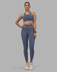 Woman wearing Fusion Ultra High-Rise 7/8 Legging Pockets - Night Shadow | Model:Rhiley | Size:S