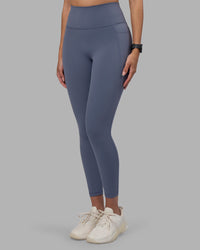 Woman wearing Fusion Ultra High-Rise 7/8 Legging Pockets - Night Shadow | Model:Rhiley | Size:S