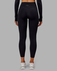 Woman wearing Fusion Ultra High-Rise 7/8 Thermal Legging Pockets - Black | Model:Ella | Size:S