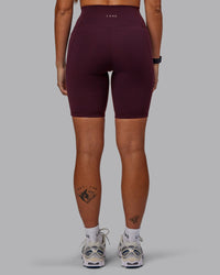 Woman wearing Fusion Ultra High-Rise 9" Short Pockets - Cherry Lacquer | Model:Vanessa | Size:S