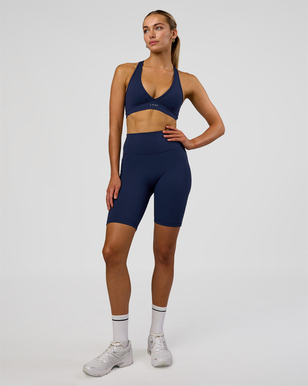 Woman wearing Fusion Ultra High-Rise 9&quot; Short Pockets - Future Navy | Model:Evie | Size:S