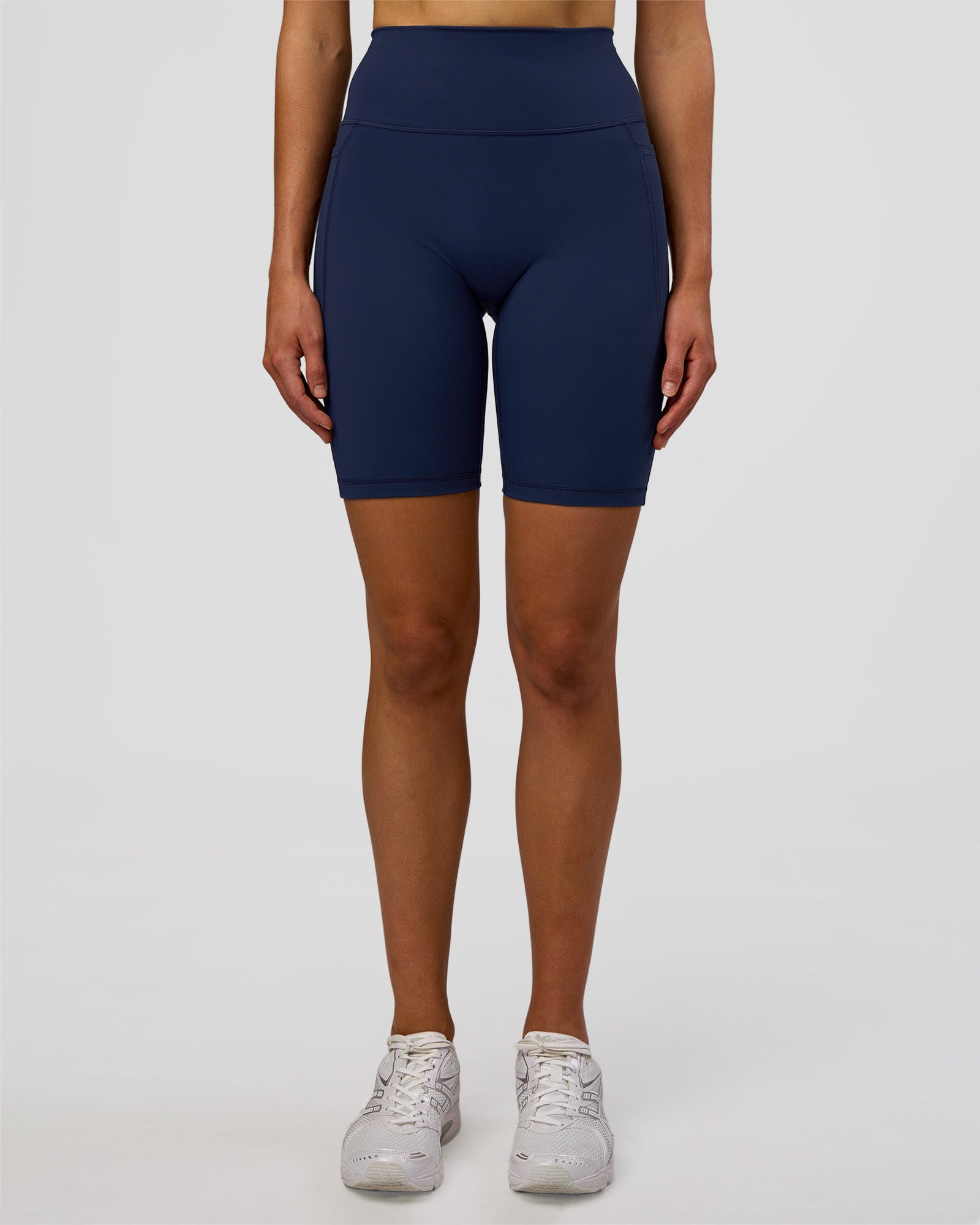 Woman wearing Fusion Ultra High-Rise 9" Short Pockets - Future Navy | Model:Evie | Size:S