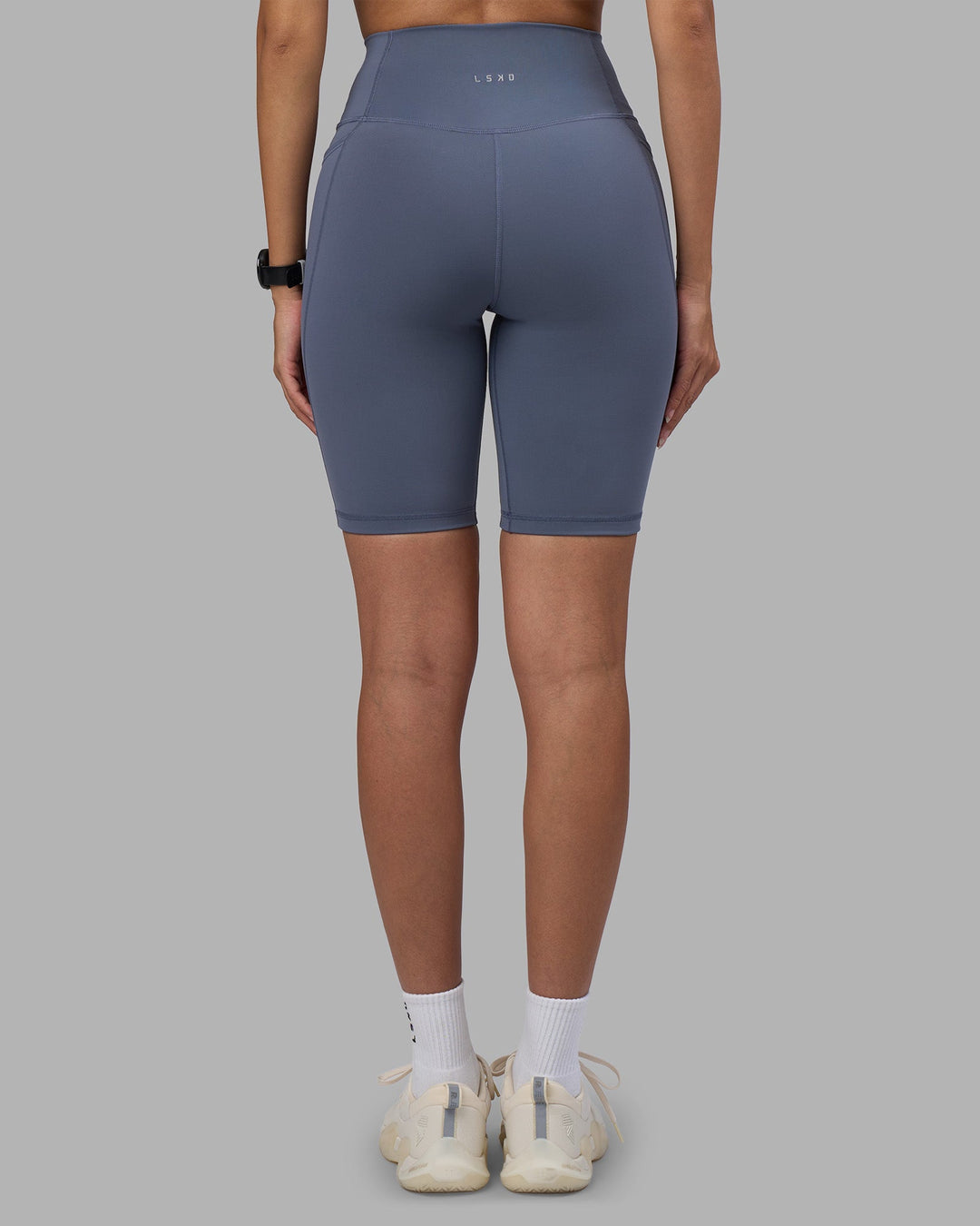 Woman wearing Fusion Ultra High-Rise 9&quot; Short Pockets - Night Shadow | Model:Rhiley | Size:S