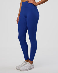 Woman wearing Fusion Ultra High-Rise Full Length Legging Pockets - Electric Indigo | Model:Evie | Size:S
