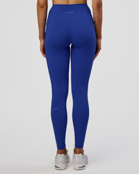 Woman wearing Fusion Ultra High-Rise Full Length Legging Pockets - Electric Indigo | Model:Evie | Size:S