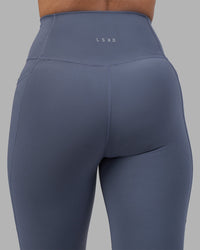 Woman wearing Fusion Ultra High-Rise Full Length Legging Pockets - Night Shadow | Model:Rhiley | Size:S