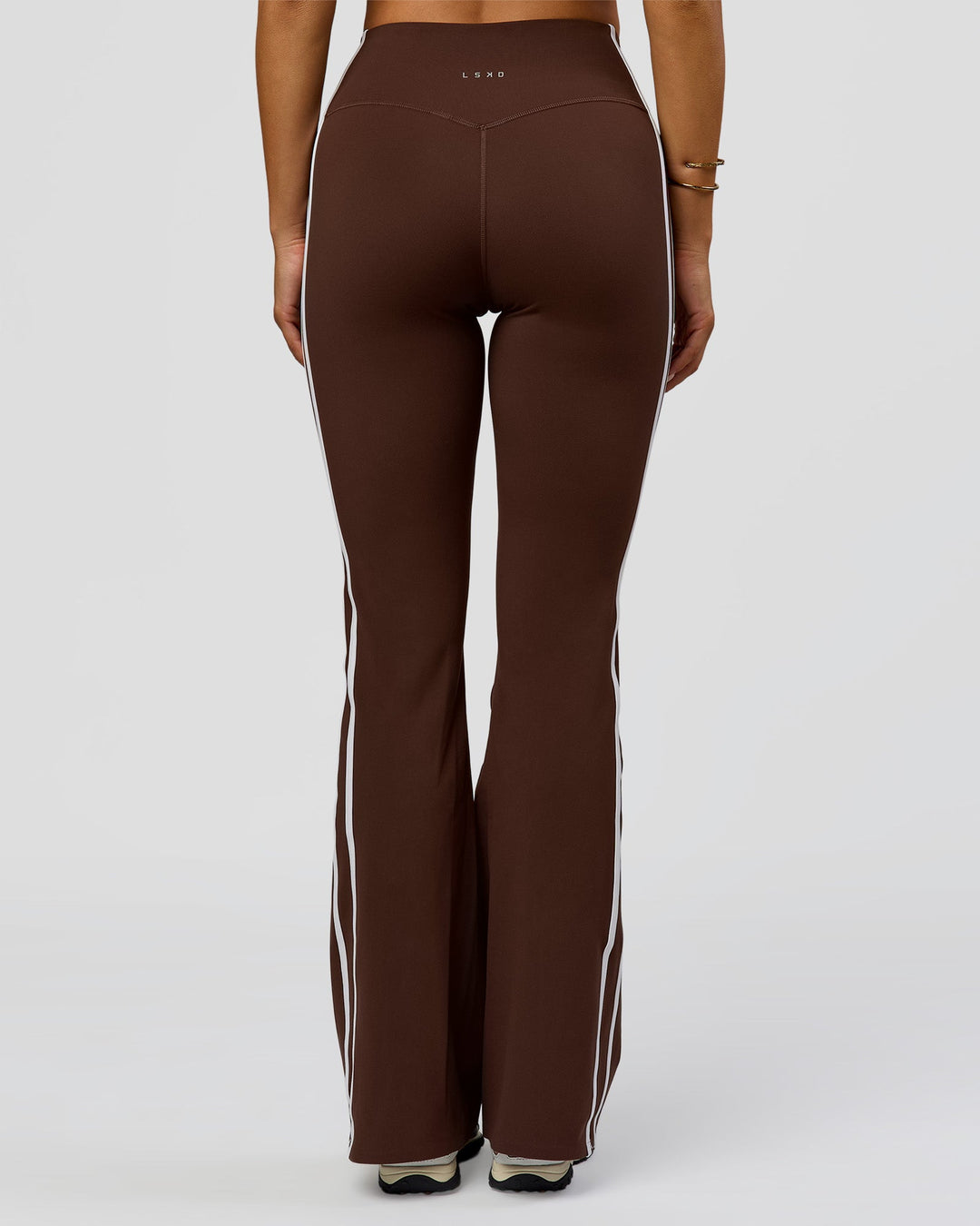 Woman wearing Fusion V-Contour Bind High-Rise Flared Legging - Hot Chocolate-white | Model:Bianca | Size:S