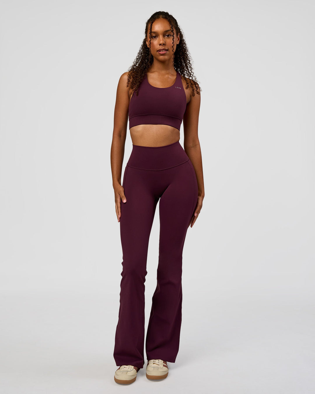 Woman wearing Fusion V-Contour High-Rise Flared Legging Pockets - Cherry Lacquer | Model:Jordan | Size:S - view 8