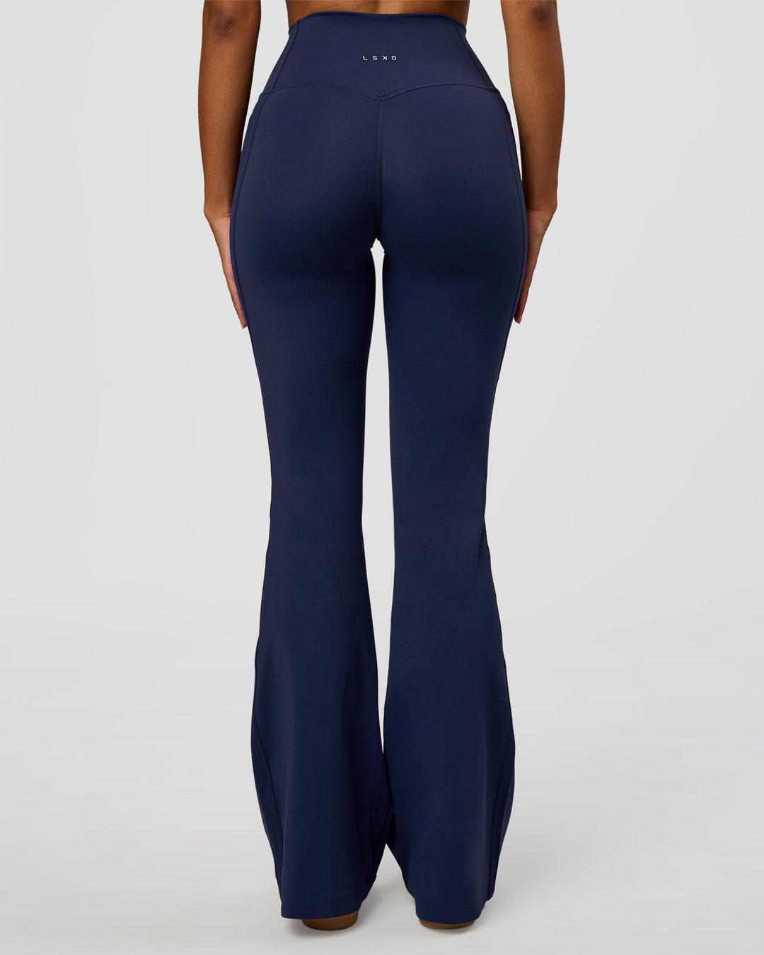 Woman wearing Fusion V-Contour High-Rise Flared Legging Pockets - Future Navy | Model:Jordan | Size:S