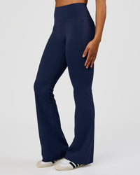 Woman wearing Fusion V-Contour High-Rise Flared Tall Legging Pockets - Future Navy | Model:Rosie | Size:S