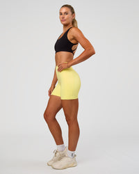 Woman wearing Fusion V-Contour Ultra High-Rise 4” Short Pockets - Yellow Fizz | Model:Emelia | Size:S