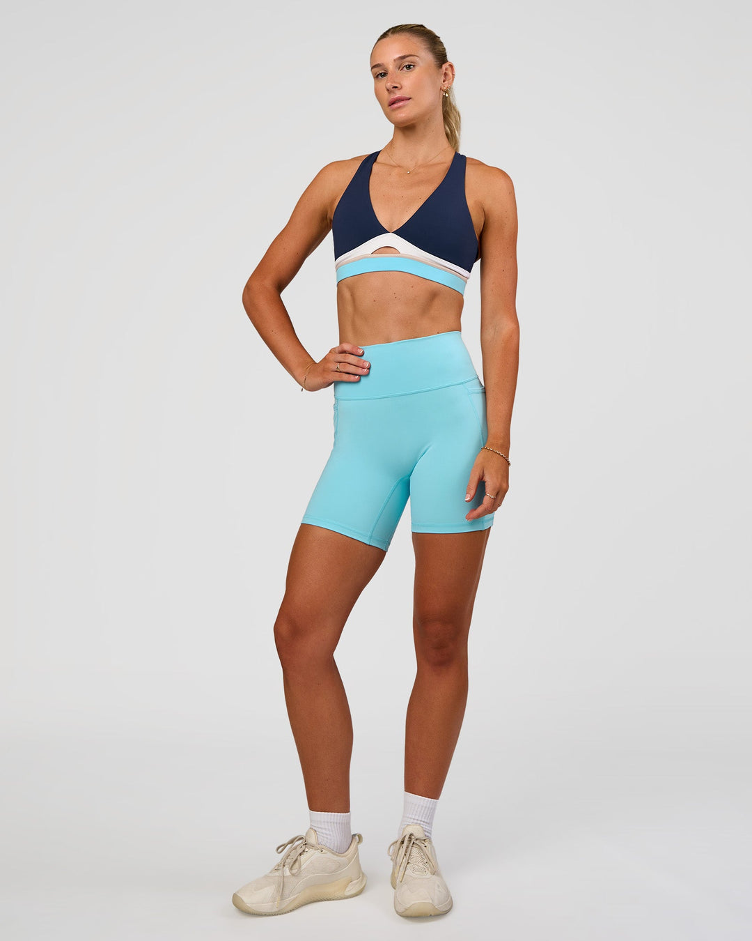 Woman wearing Fusion V-Contour Ultra High-Rise 6" Short Pockets - Baltic Sea | Model:Emelia | Size:S