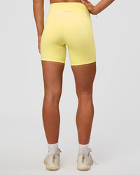 Woman wearing Fusion V-Contour Ultra High-Rise 6" Short Pockets - Yellow Fizz | Model:Emelia | Size:S