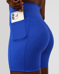 Woman wearing Fusion V-Contour Ultra High-Rise 4” Short Pockets - Electric Indigo | Model:Ellie | Size:S