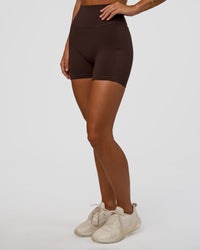 Woman wearing Fusion V-Contour Ultra High-Rise 4” Short Pockets - Hot Chocolate | Model:Amity | Size:S