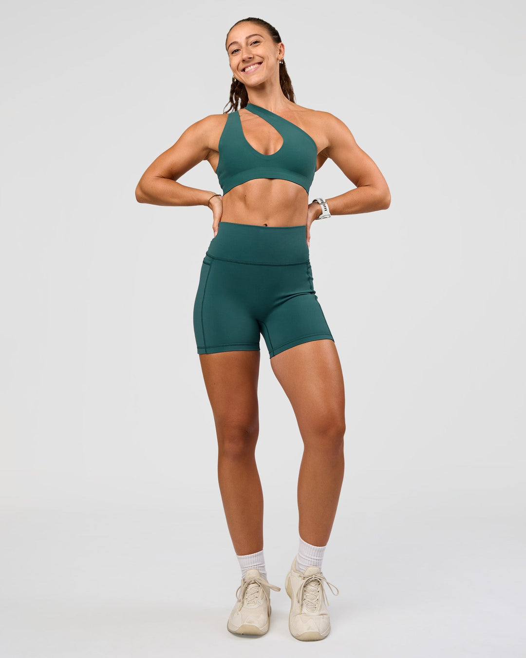 Woman wearing Fusion V-Contour Ultra High-Rise 4” Short Pockets - Transformative Teal | Model:Summer | Size:S