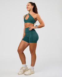 Woman wearing Fusion V-Contour Ultra High-Rise 4” Short Pockets - Transformative Teal | Model:Summer | Size:S