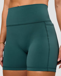 Woman wearing Fusion V-Contour Ultra High-Rise 4” Short Pockets - Transformative Teal | Model:Summer | Size:S