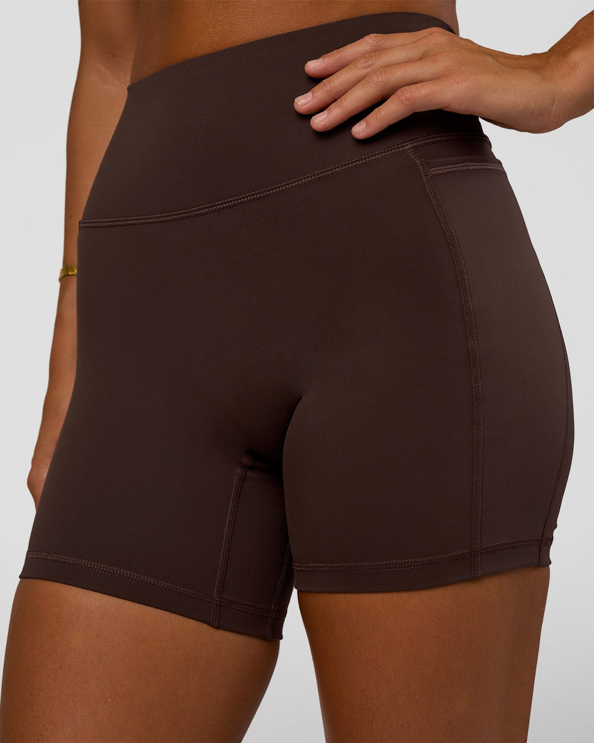 Woman wearing Fusion V-Contour Ultra High-Rise 6" Short Pockets - Hot Chocolate | Model:Amity | Size:S