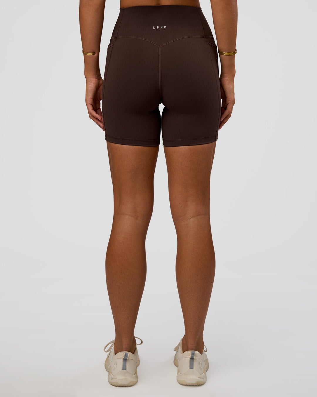 Woman wearing Fusion V-Contour Ultra High-Rise 6&quot; Short Pockets - Hot Chocolate | Model:Amity | Size:S