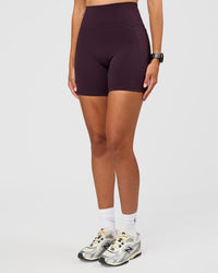 Woman wearing Fusion V-Contour Ultra High-Rise 6" Short Pockets - Midnight Plum | Model:Rhiley | Size:S