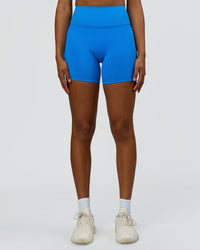 Woman wearing Fusion V-Contour Ultra High-Rise 6" Short Pockets - Palace Blue | Model:Rosie | Size:S