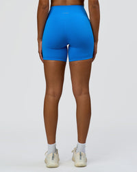 Woman wearing Fusion V-Contour Ultra High-Rise 6" Short Pockets - Palace Blue | Model:Rosie | Size:S