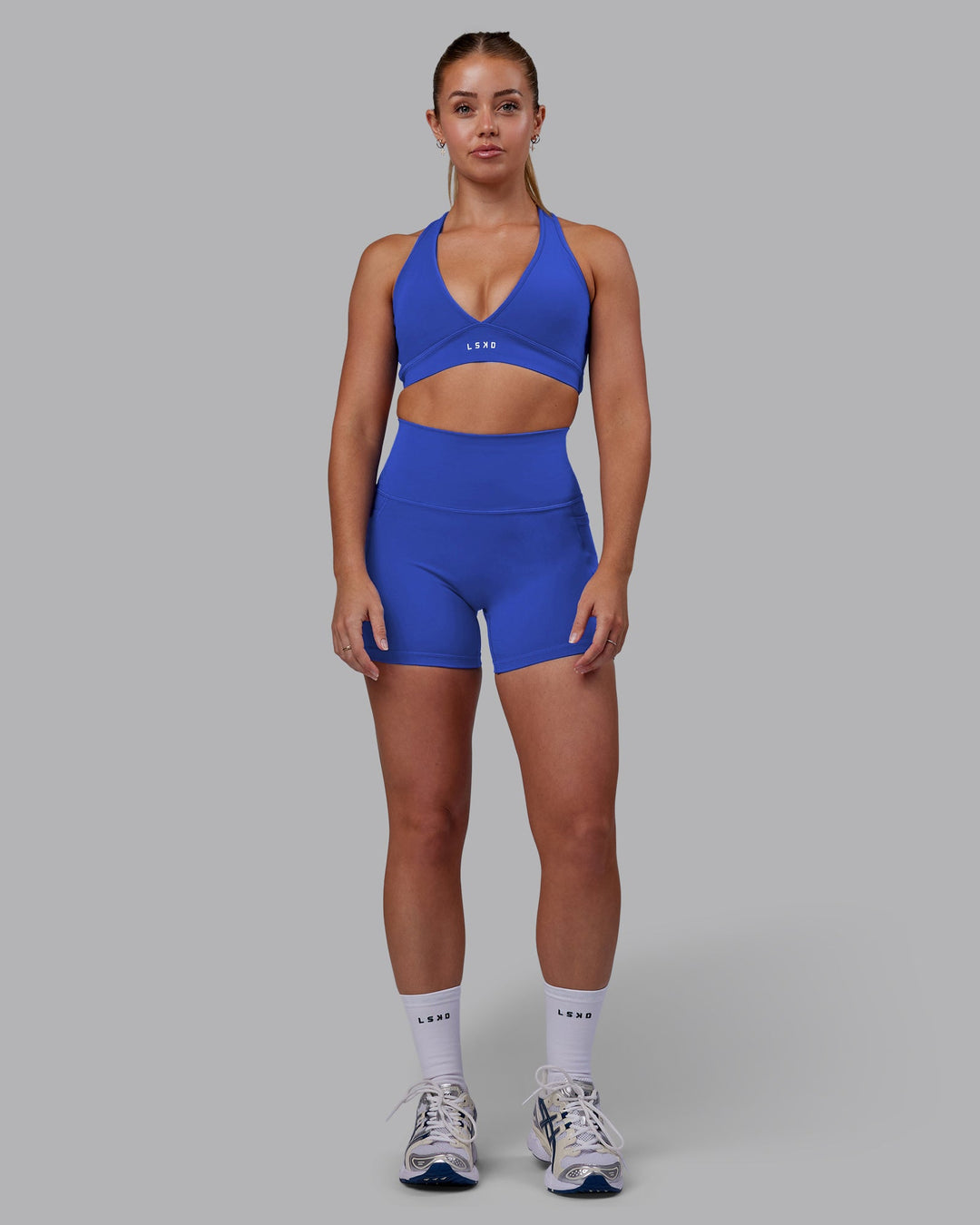 Woman wearing Fusion Ultra High-Rise 4" Short Pockets - Power Cobalt | Model:Hannah | Size:S