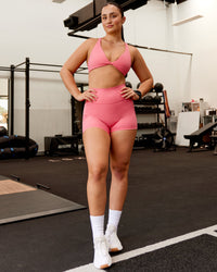 Woman wearing Fusion Ultra High-Rise 4" Short Pockets - Pink Lemonade | Model:Charlotte | Size:S