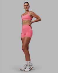 Woman wearing Fusion Ultra High-Rise 4" Short Pockets - Pink Lemonade | Model:Shae | Size:S