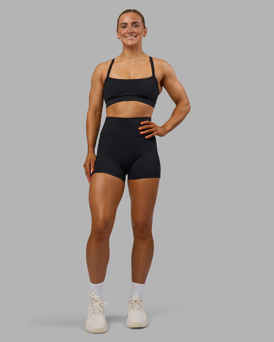 Woman wearing Fusion Ultra High-Rise 4" Short Pockets - Black | Model:Georgia | Size:S
