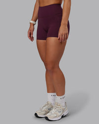 Woman wearing Fusion Ultra High-Rise 4" Short Pockets - Cherry Lacquer | Model:Lyss | Size:S