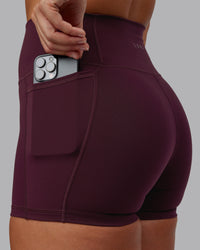 Woman wearing Fusion Ultra High-Rise 4" Short Pockets - Cherry Lacquer | Model:Lyss | Size:S