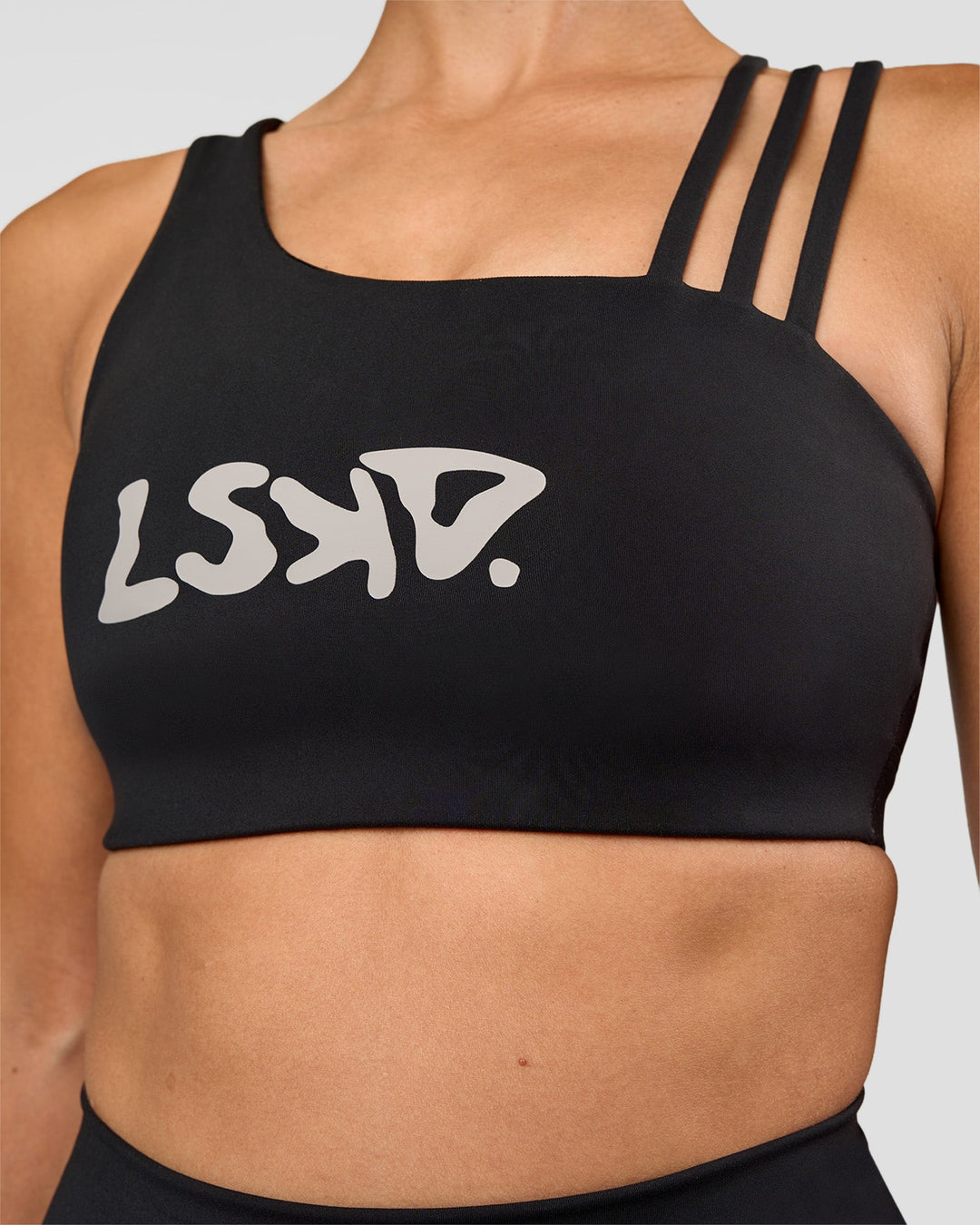 Woman wearing Galvanise Hype Graphic Sports Bra 2.0 - Black-Alloy | Model:Rhiley | Size:S - view 6