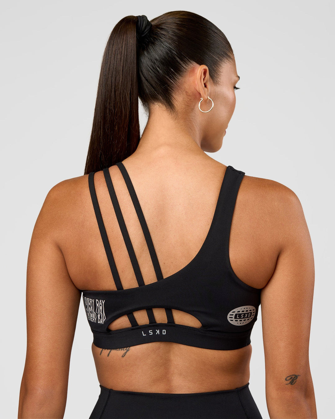 Woman wearing Galvanise Hype Graphic Sports Bra 2.0 - Black-Alloy | Model:Rhiley | Size:S - view 8