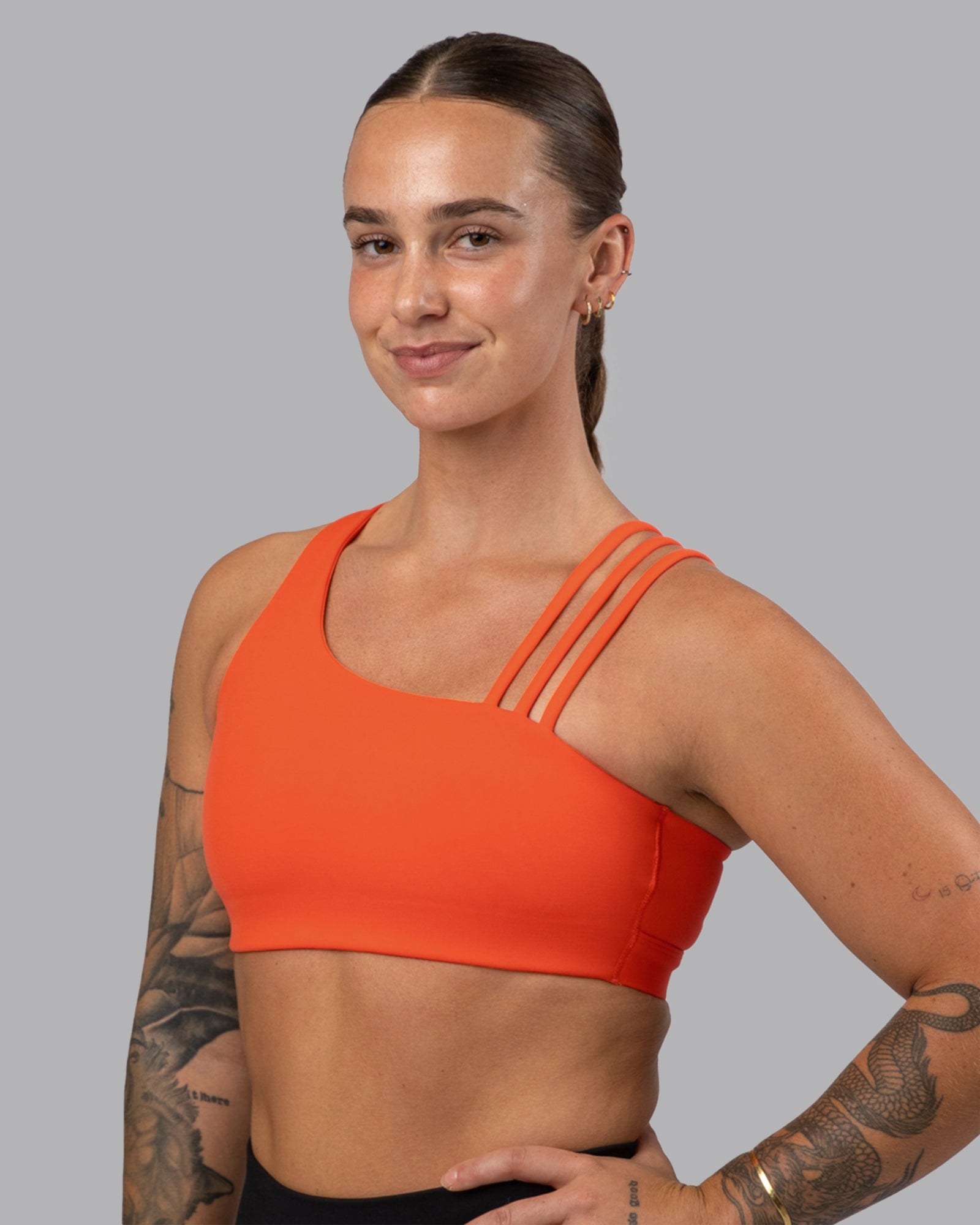 Woman wearing Galvanise Sports Bra 2.0 - Ultra Orange | Model:Robyn | Size:S