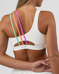 Woman wearing Galvanise Sports Bra 2.0 - Off White-Multi | Model:Amity | Size:S