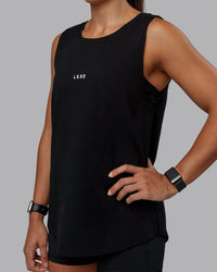 Woman wearing Go-To FLXCotton Longline Tank - Black-White | Size:S | Model:Tylah