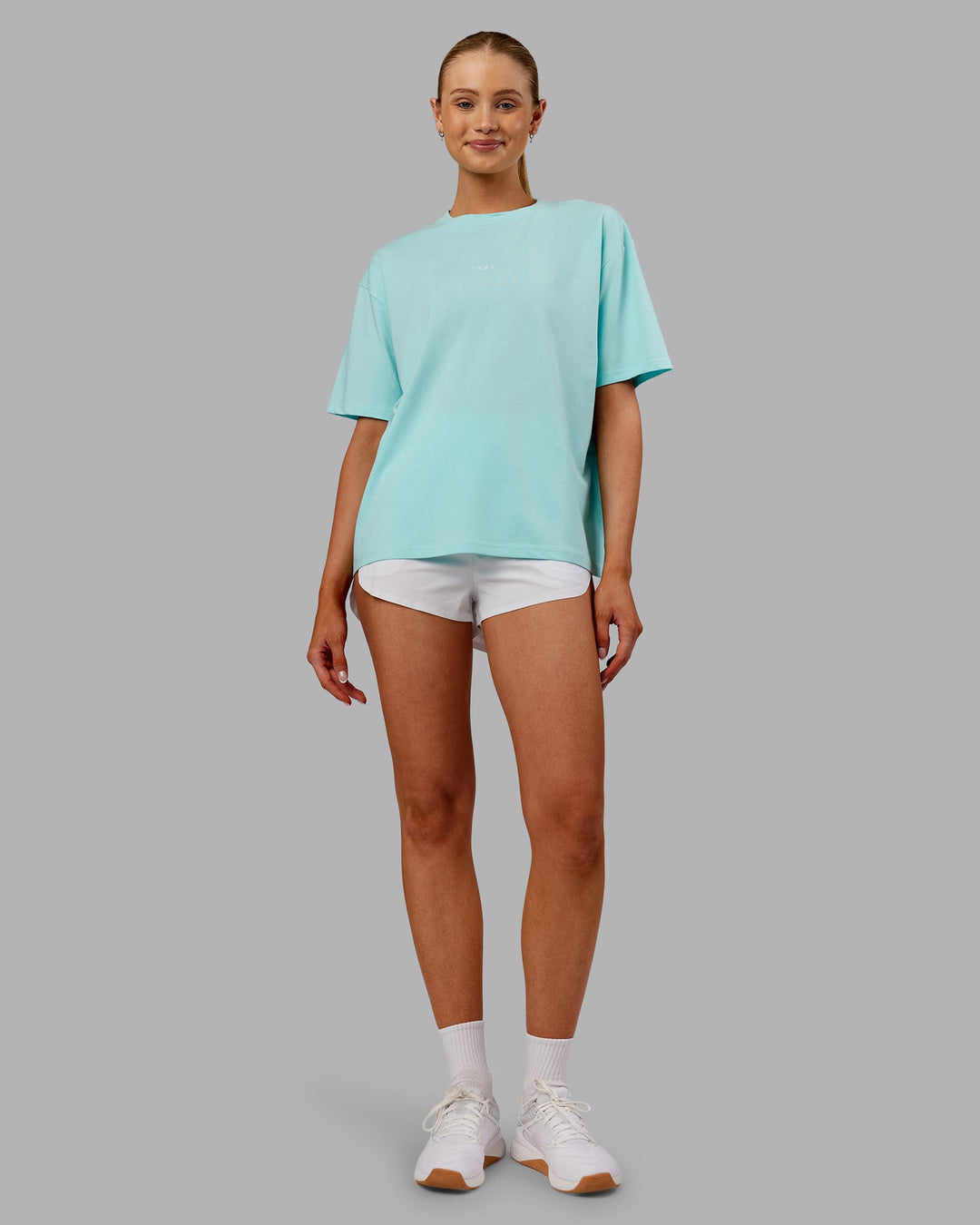 Woman wearing Go-To FLXCotton Oversized Tee - Island Paradise-White | Model:Ella | Size:S