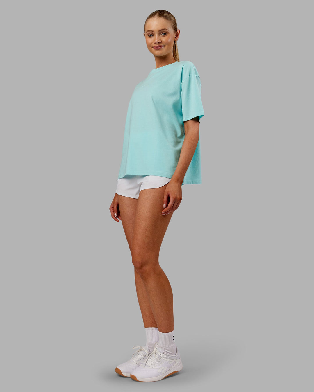 Woman wearing Go-To FLXCotton Oversized Tee - Island Paradise-White | Model:Ella | Size:S