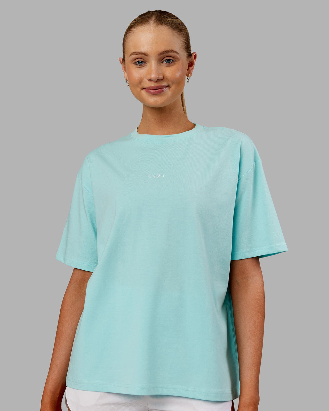 Woman wearing Go-To FLXCotton Oversized Tee - Island Paradise-White | Model:Ella | Size:S