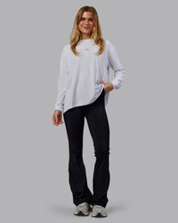 Woman wearing Go-To Long Sleeve FLXCotton Oversized Tee - White-Black | Model:Emilie | Size:S