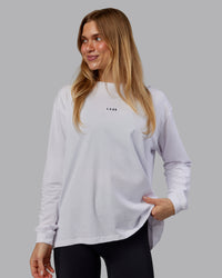 Woman wearing Go-To Long Sleeve FLXCotton Oversized Tee - White-Black | Model:Emilie | Size:S