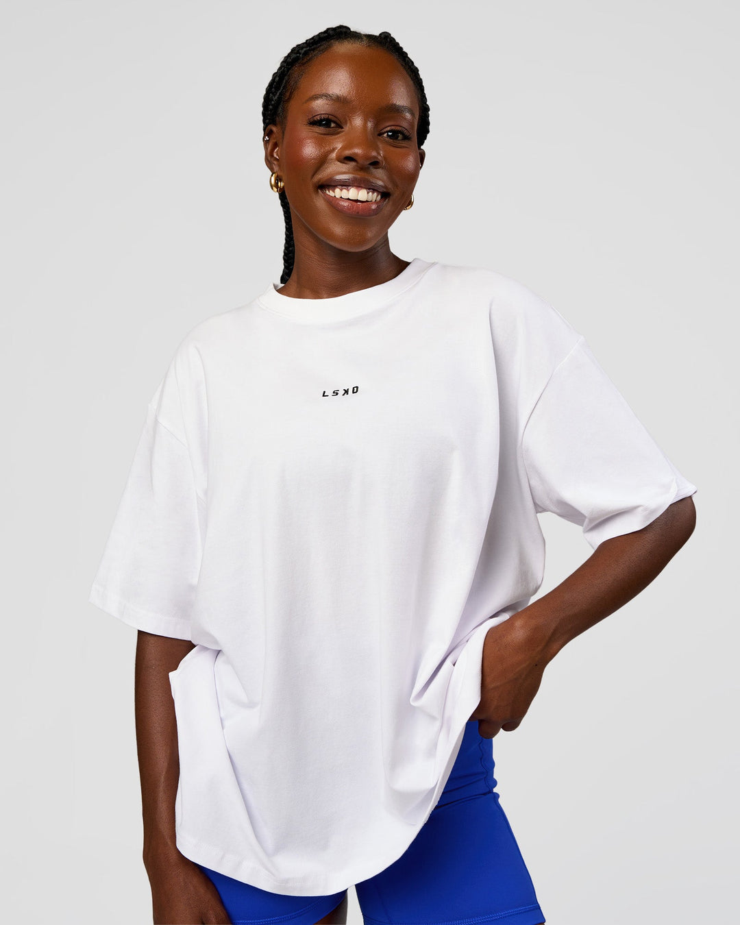 Woman wearing Go-To Run Club FLXCotton Oversized Tee - White-Electric Indigo | Model:Ellie | Size:S - view 2