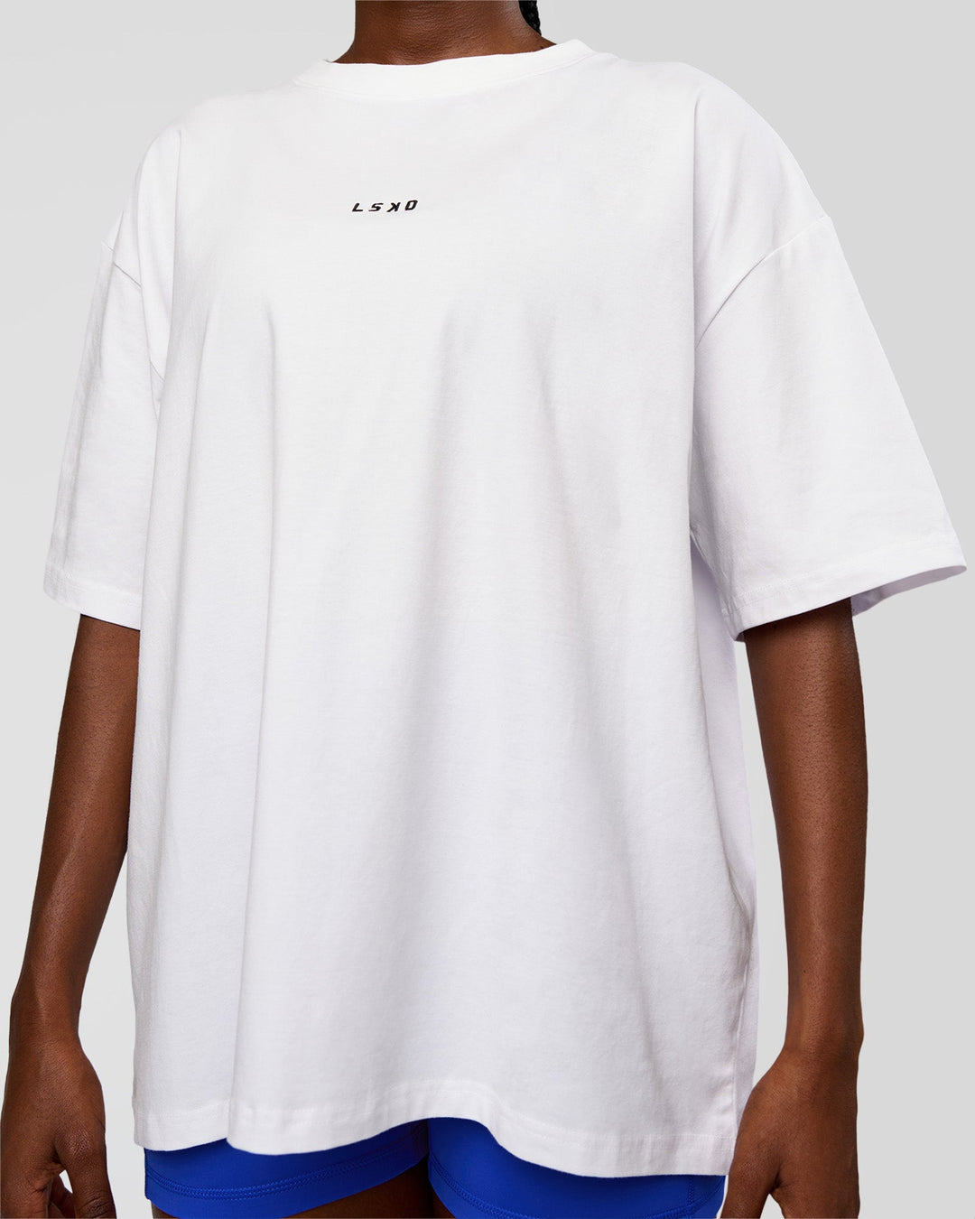 Woman wearing Go-To Run Club FLXCotton Oversized Tee - White-Electric Indigo | Model:Ellie | Size:S - view 4