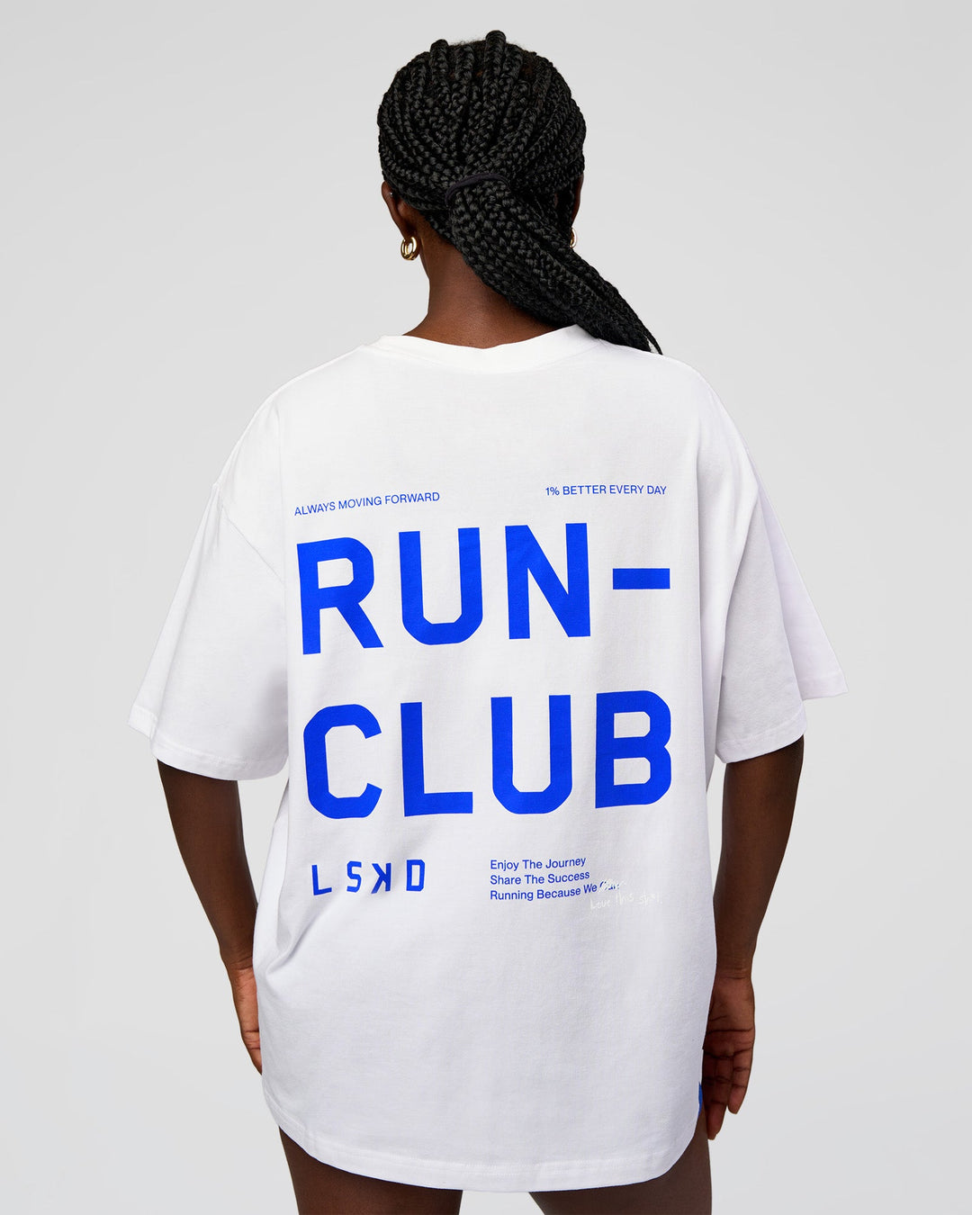 Woman wearing Go-To Run Club FLXCotton Oversized Tee - White-Electric Indigo | Model:Ellie | Size:S - view 1
